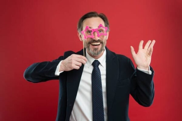 Cheerful businessman in party photo booth props. Guy enjoying party carnival. Holiday party celebration. Having fun. Office party corporate. Join carnival. Man formal suit wear fake glasses accessory.